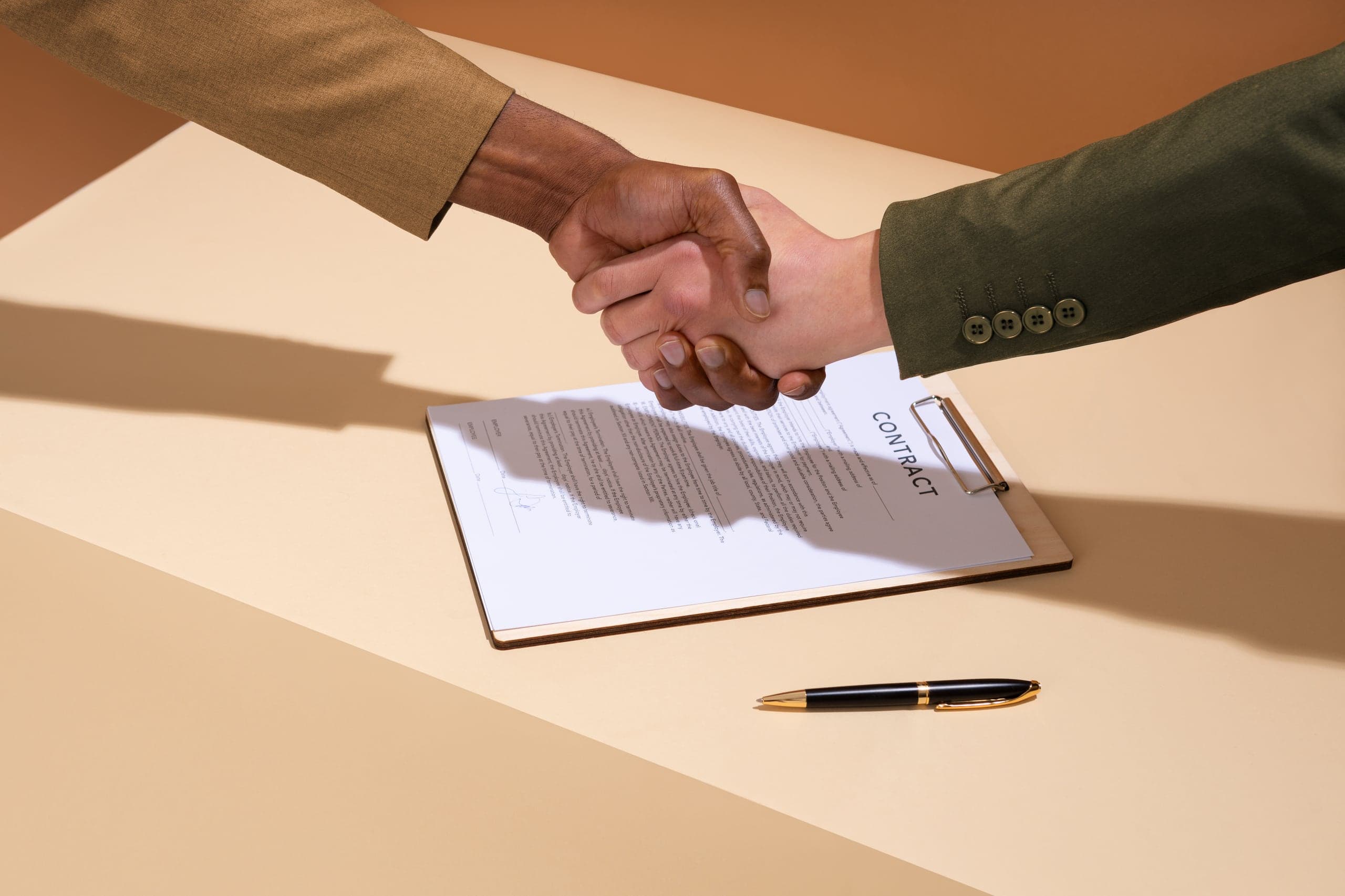 People shaking hands across a table